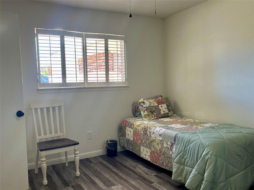 5302 Vale Street Greenville, TX 75402 - Photo 25 of 33 a bedroom with a bed and a window
