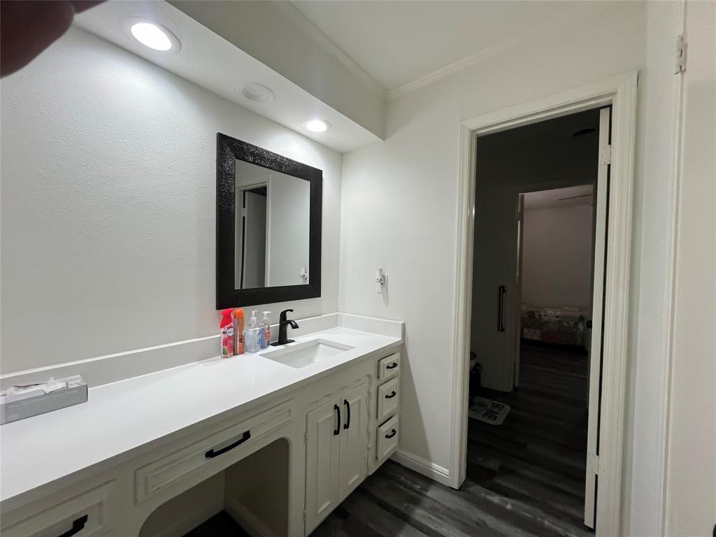 5302 Vale Street Greenville, TX 75402 - Photo 30 of 33 a bathroom with a sink and a mirror