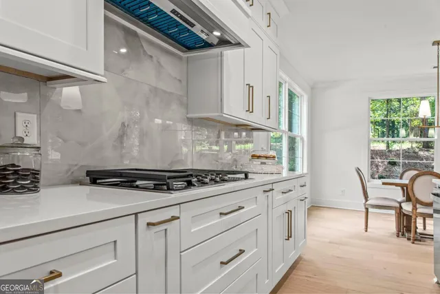 a kitchen with white cabinets and white appliances