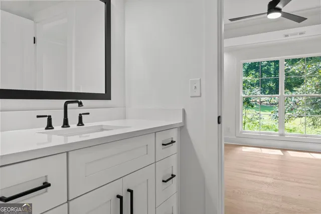 a view of an empty room with wooden floor and closet area