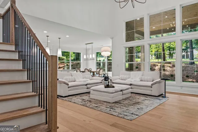 a living room with furniture and large windows