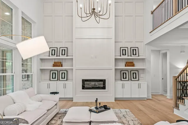 a living room with furniture and wall paintings