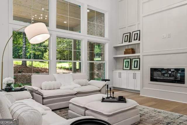 a living room with furniture and a floor to ceiling window