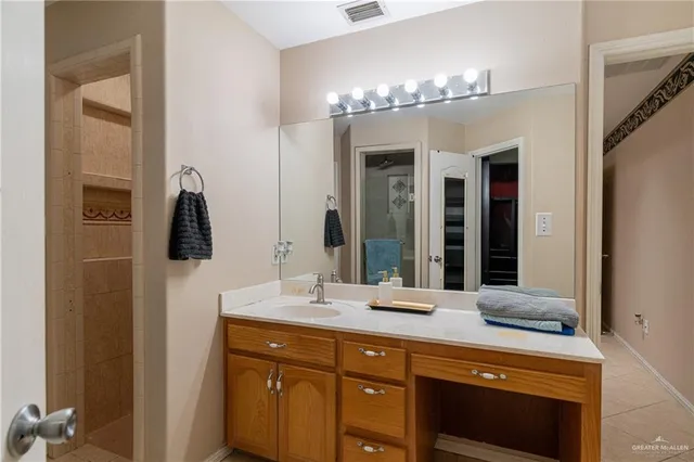 a bathroom with a double vanity sink and a mirror