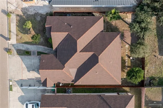 an aerial view of multiple houses with yard