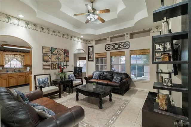 a living room with furniture and a ceiling fan