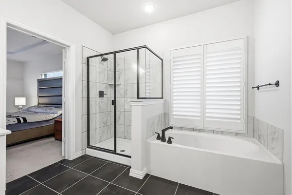 a bathroom with a tub and a shower