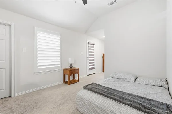 a bedroom with a bed and a chair