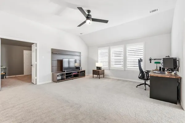 a view of a livingroom with workspace and a window