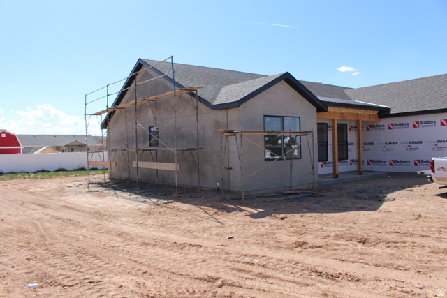 4933 East Remington Road Cedar City, UT 84721 - Photo 30 of 33 New construction featuring a dark shingled roof, stucco exterior, and black-framed windows