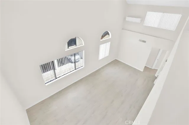 a view of a room with wooden floor