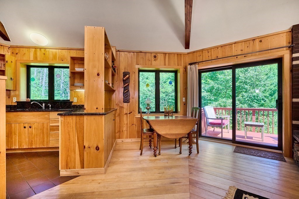 90 Patterson Road Worthington, MA 01098 - Photo 8 of 30 a dining room with wooden floor an glass table and chairs