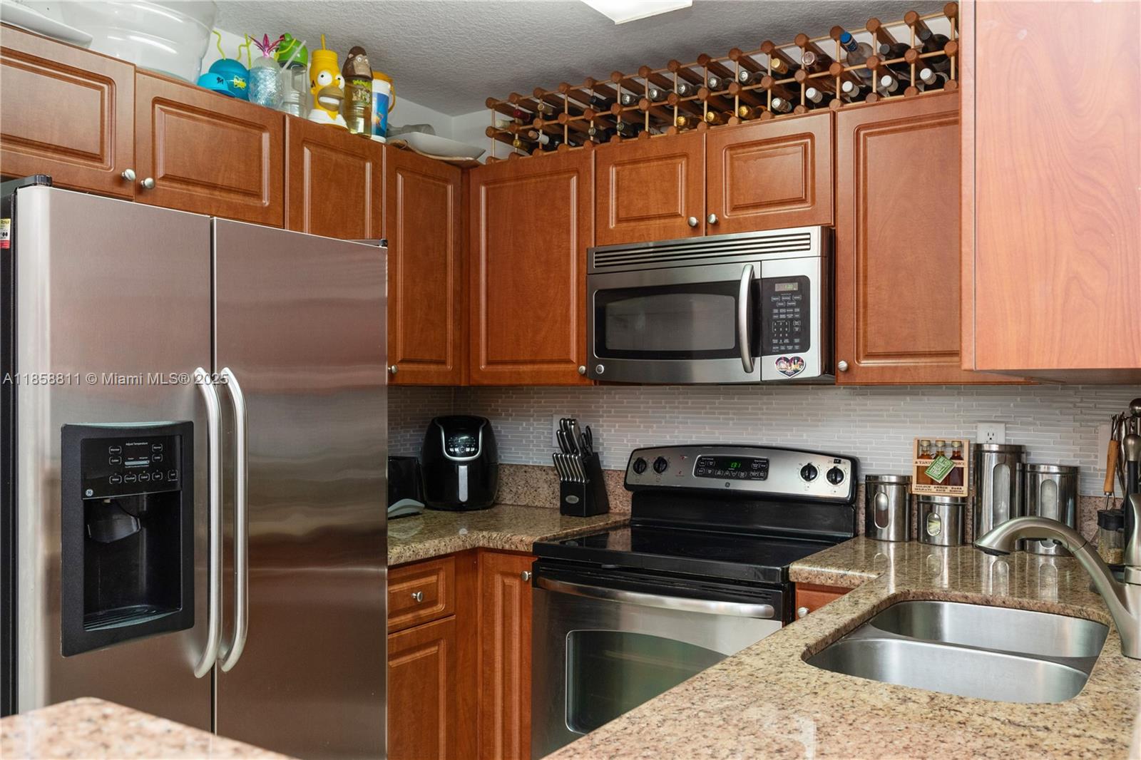 1068 Southwest 143rd Avenue, Unit 2510 Pembroke Pines, FL 33027 - Photo 13 of 49 a kitchen with stainless steel appliances granite countertop a refrigerator a stove top oven a sink and dishwasher