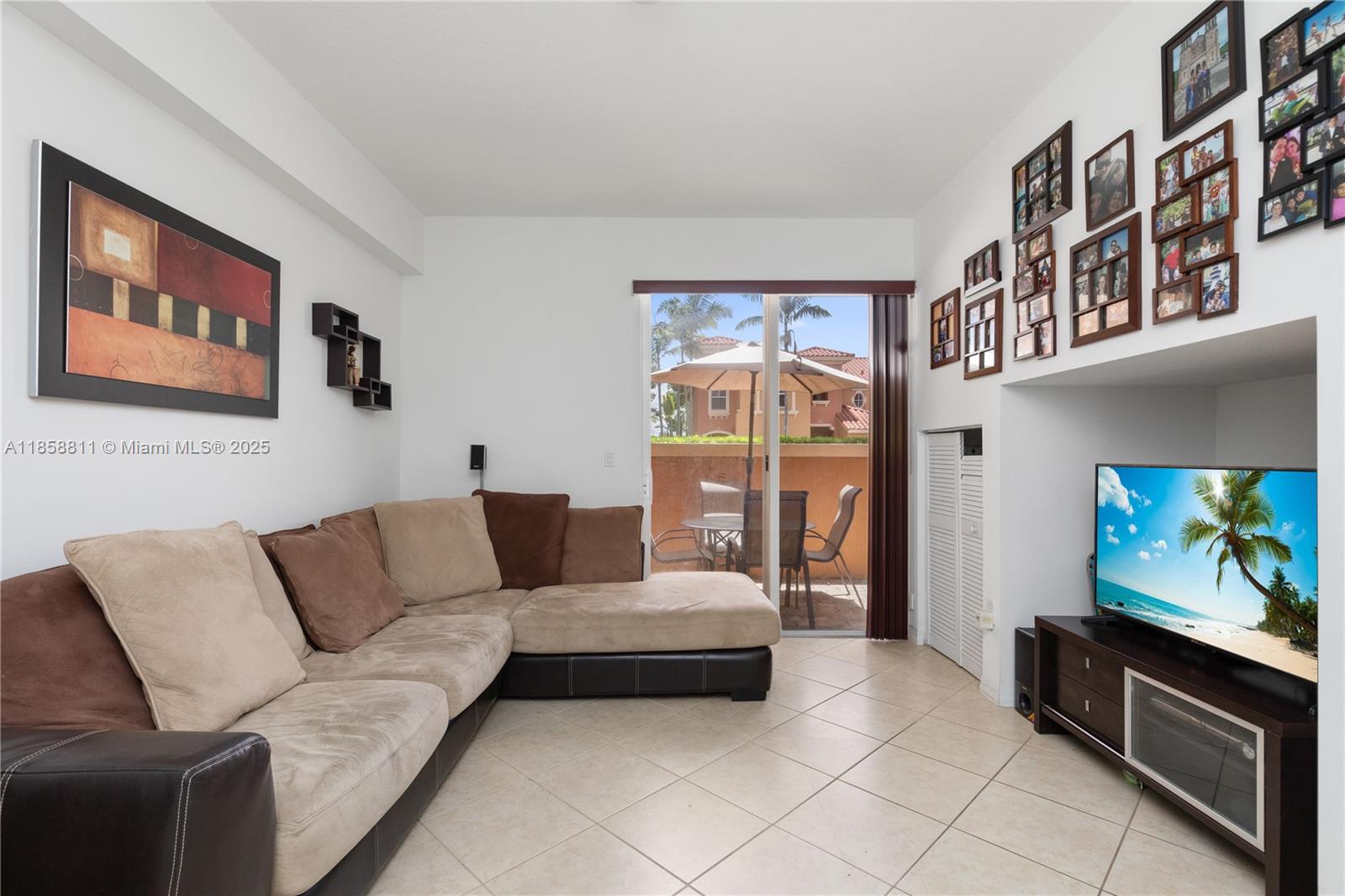 1068 Southwest 143rd Avenue, Unit 2510 Pembroke Pines, FL 33027 - Photo 15 of 49 a living room with furniture and a flat screen tv