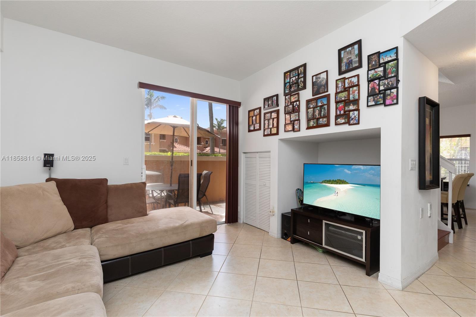 1068 Southwest 143rd Avenue, Unit 2510 Pembroke Pines, FL 33027 - Photo 16 of 49 a living room with furniture and a flat screen tv