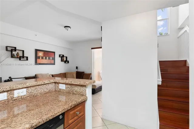 a kitchen with granite countertop a sink and a stove