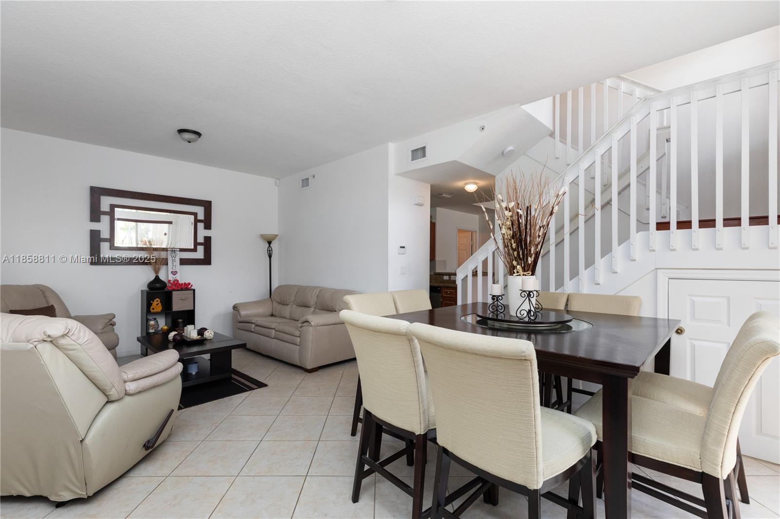 1068 Southwest 143rd Avenue, Unit 2510 Pembroke Pines, FL 33027 - Photo 2 of 49 a living room with furniture a large window and a potted plant