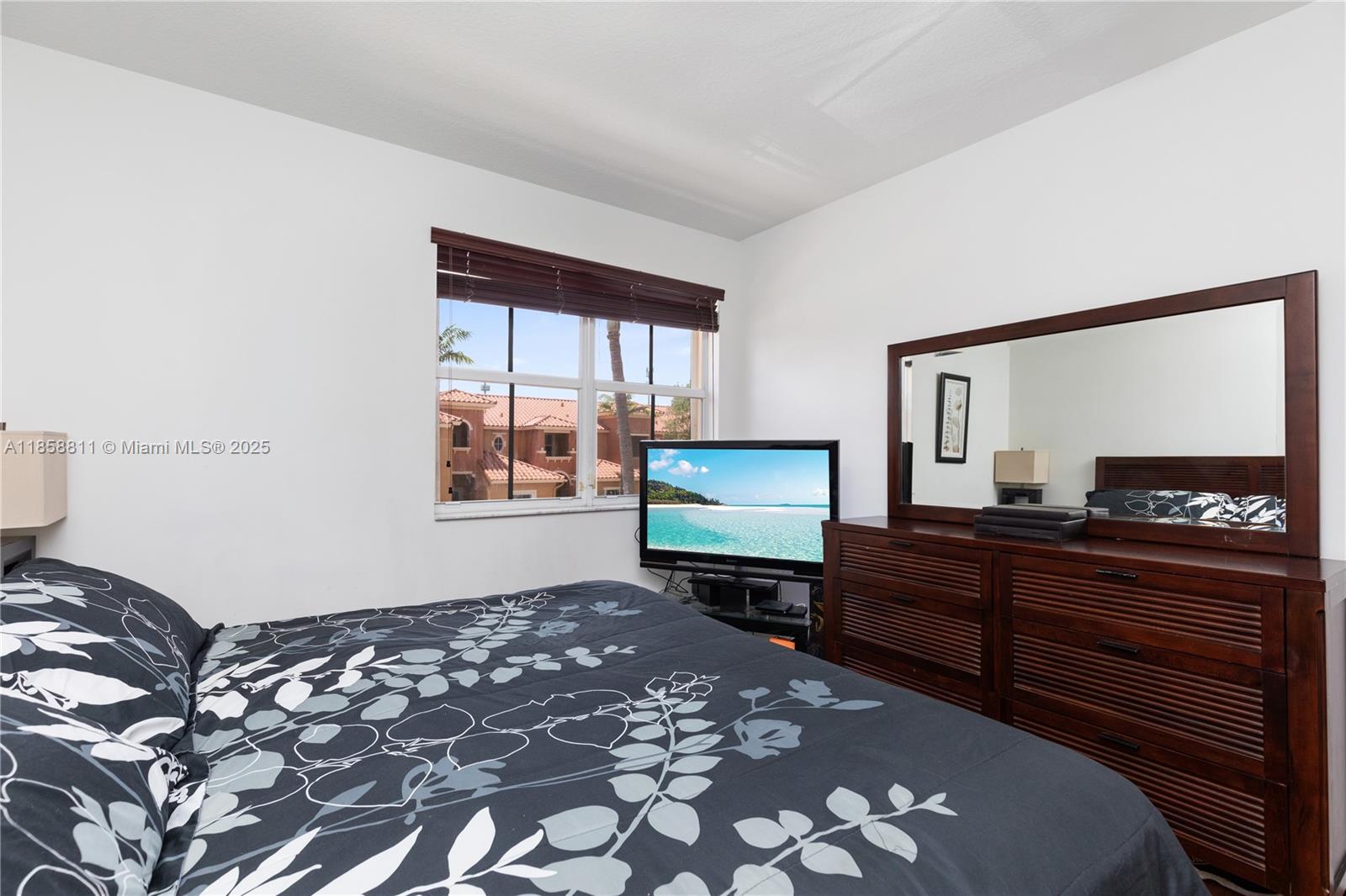 1068 Southwest 143rd Avenue, Unit 2510 Pembroke Pines, FL 33027 - Photo 22 of 49 a bedroom with a bed window and dresser