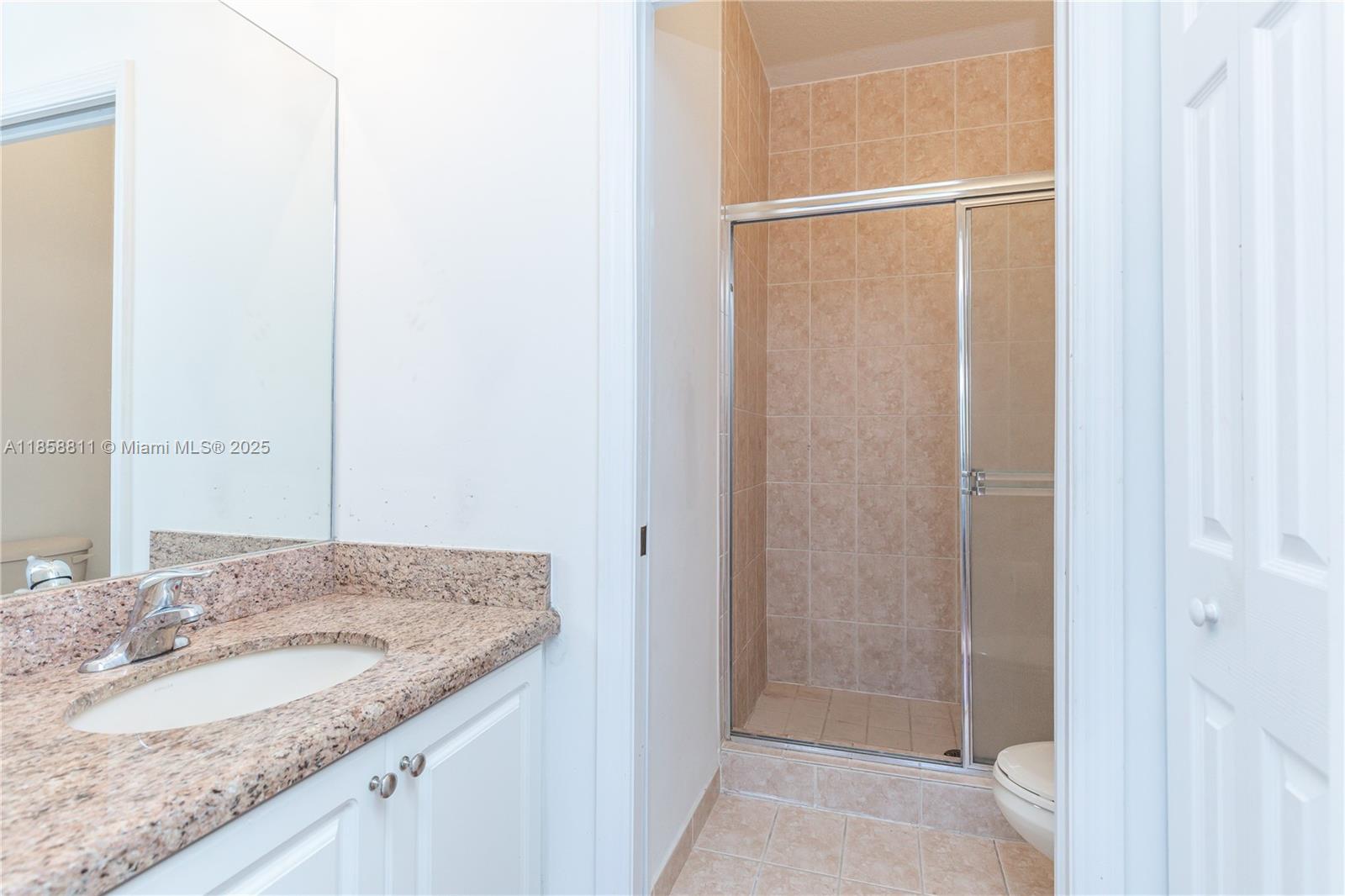 1068 Southwest 143rd Avenue, Unit 2510 Pembroke Pines, FL 33027 - Photo 24 of 49 a bathroom with a granite countertop sink and a mirror