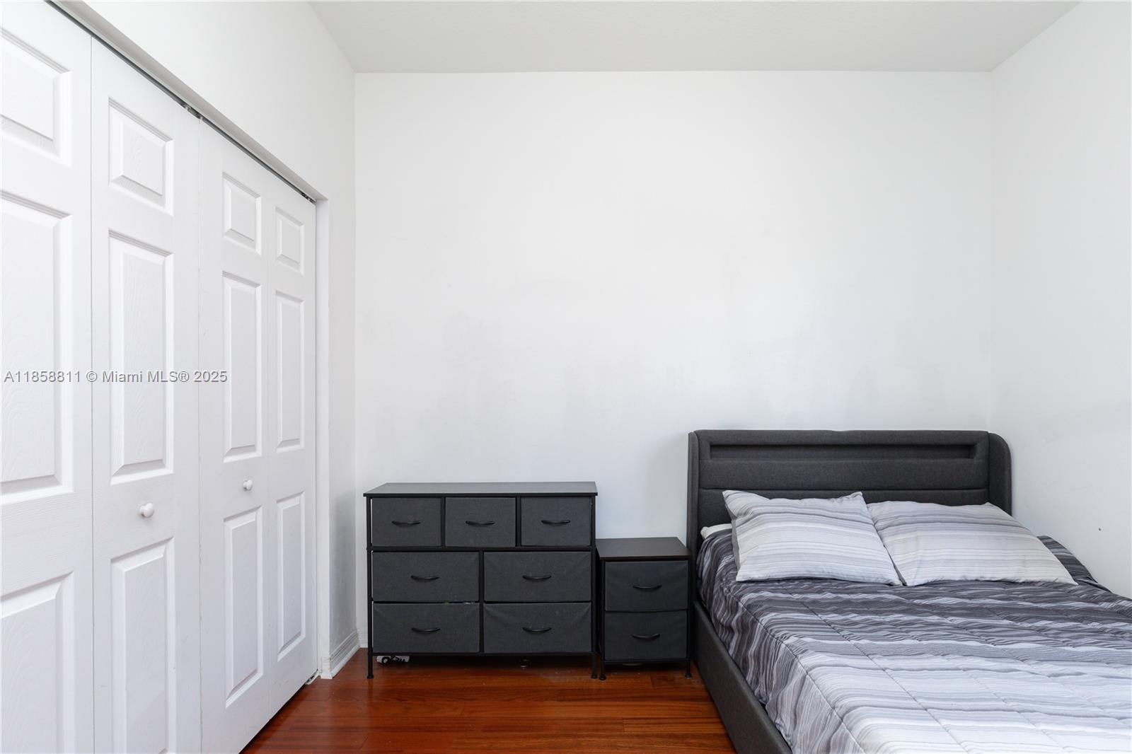 1068 Southwest 143rd Avenue, Unit 2510 Pembroke Pines, FL 33027 - Photo 31 of 49 a bedroom with a bed and cabinets