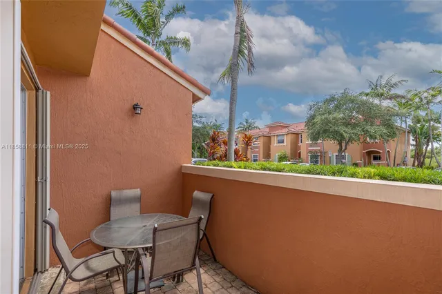 a view of a chair and table in the balcony