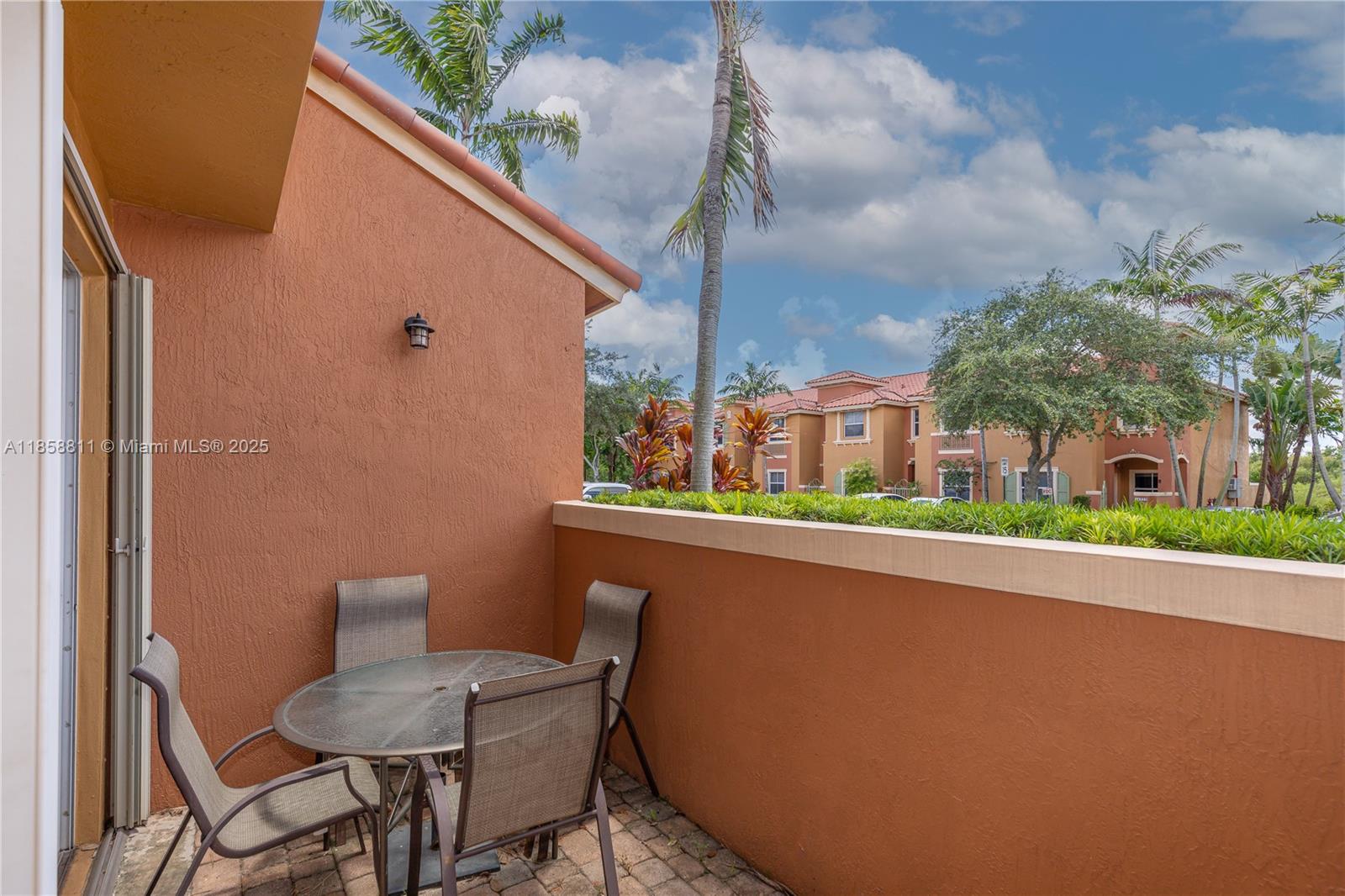 1068 Southwest 143rd Avenue, Unit 2510 Pembroke Pines, FL 33027 - Photo 36 of 49 a view of a chair and table in the balcony
