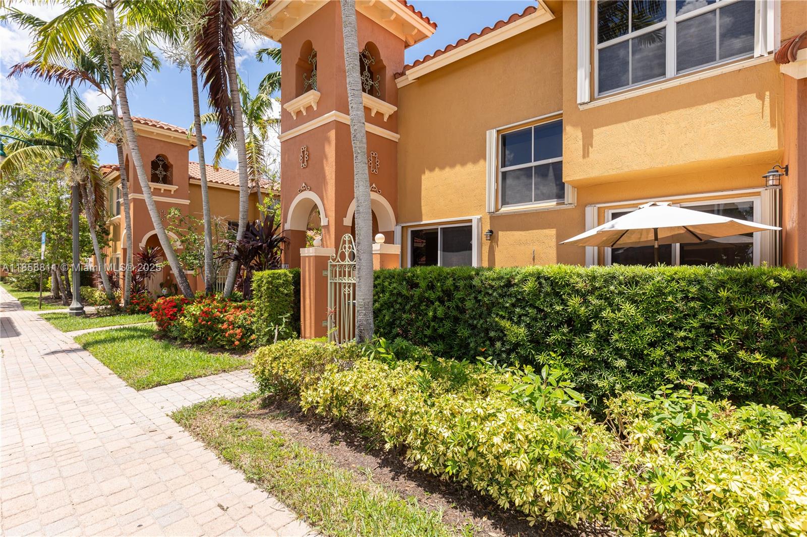 1068 Southwest 143rd Avenue, Unit 2510 Pembroke Pines, FL 33027 - Photo 42 of 49 a view of a building with a garden