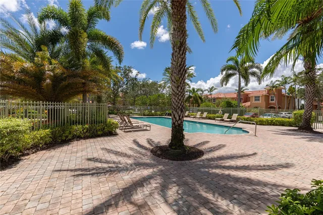 a swimming pool with outdoor seating and yard