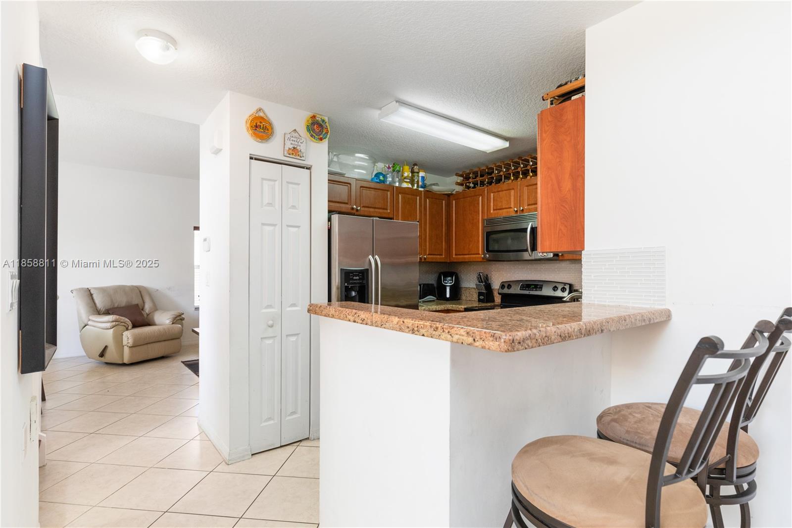 1068 Southwest 143rd Avenue, Unit 2510 Pembroke Pines, FL 33027 - Photo 10 of 49 a kitchen with stainless steel appliances granite countertop a refrigerator and a stove