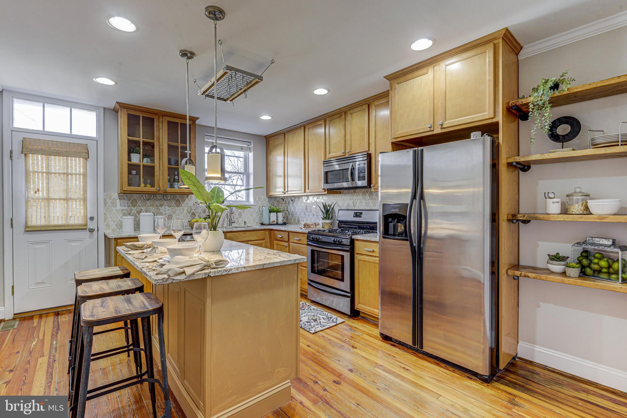3625 Keswick Road Baltimore, MD 21211 - Photo 3 of 47 a kitchen with stainless steel appliances granite countertop a refrigerator a sink dishwasher a stove and a refrigerator with wooden floor