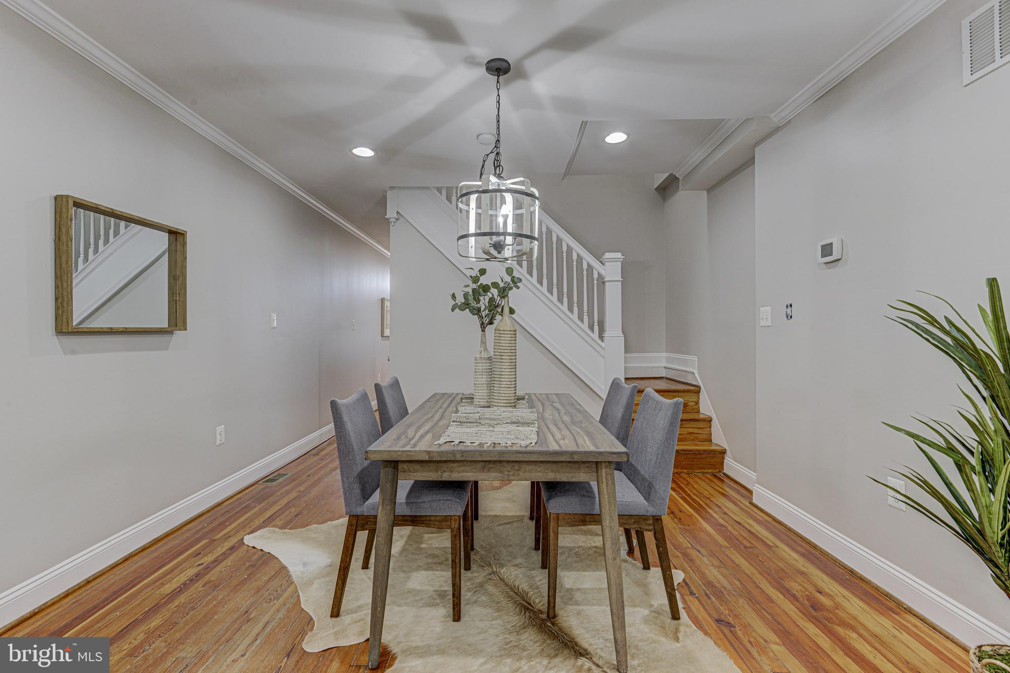 3625 Keswick Road Baltimore, MD 21211 - Photo 22 of 47 a view of a dining room with furniture wooden floor and chandelier