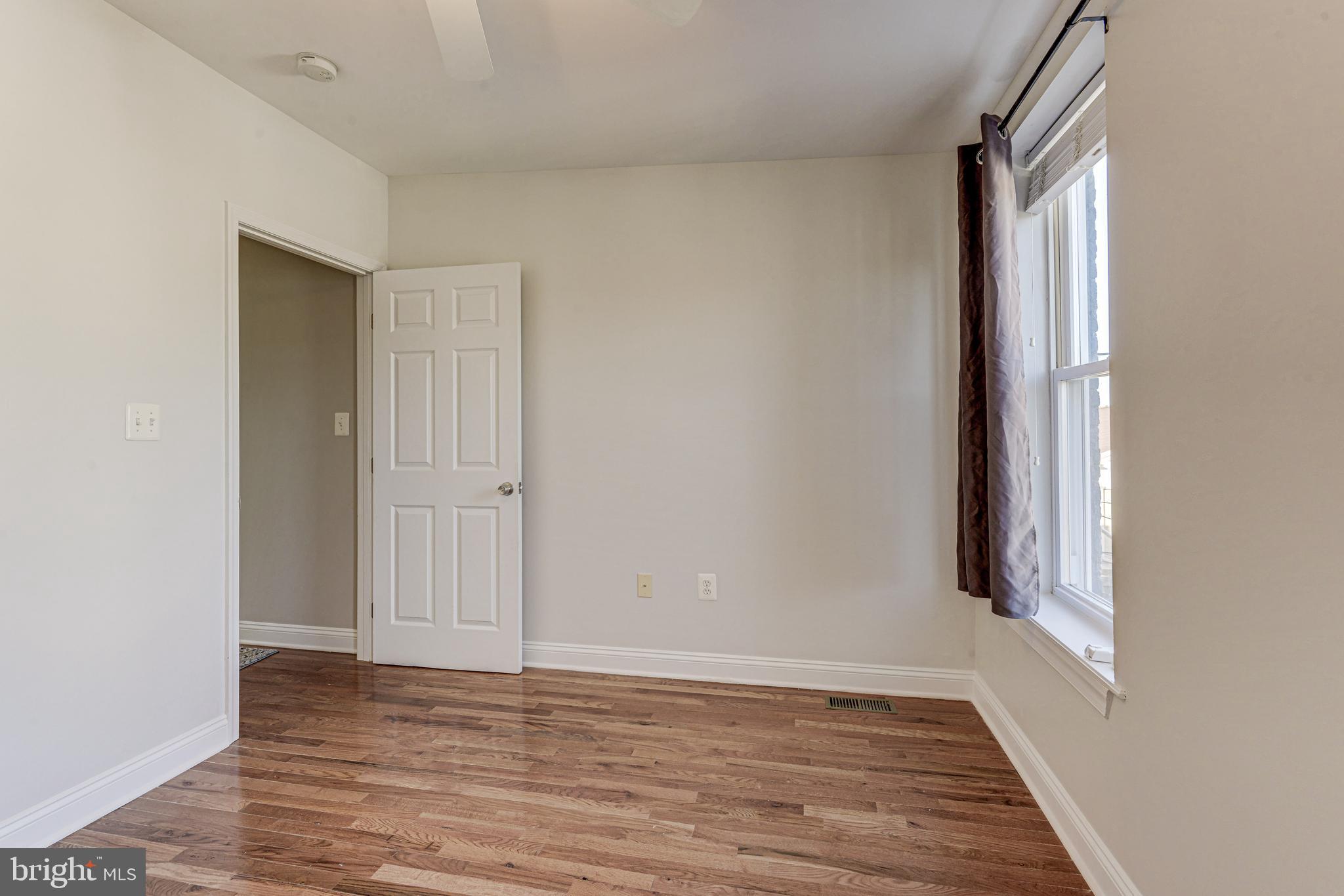 3625 Keswick Road Baltimore, MD 21211 - Photo 40 of 47 a view of an empty room with wooden floor and a window