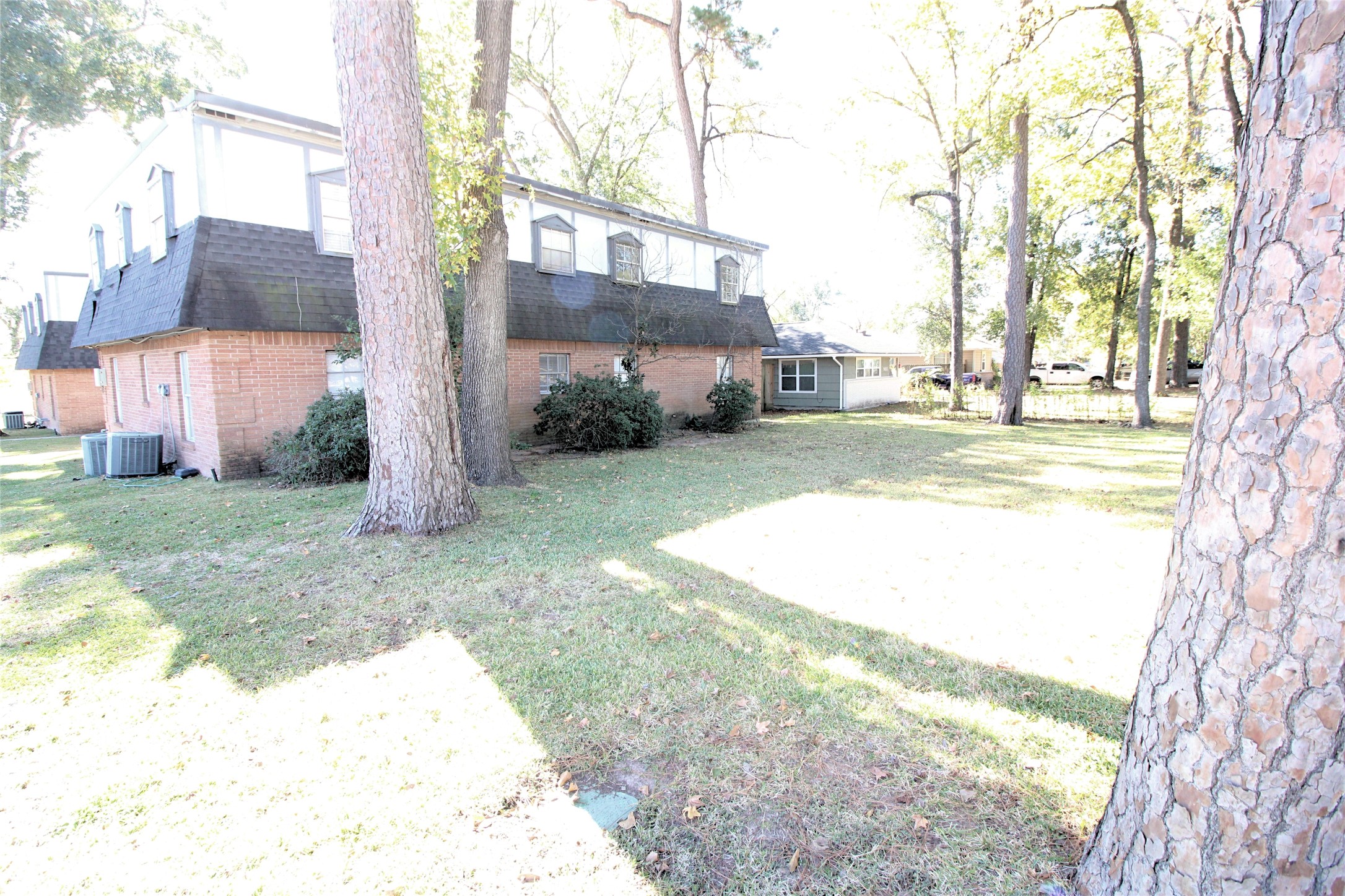 1305 Adams Street, Unit 1 Conroe, TX 77301 - Photo 13 of 14 a view of a backyard with large trees