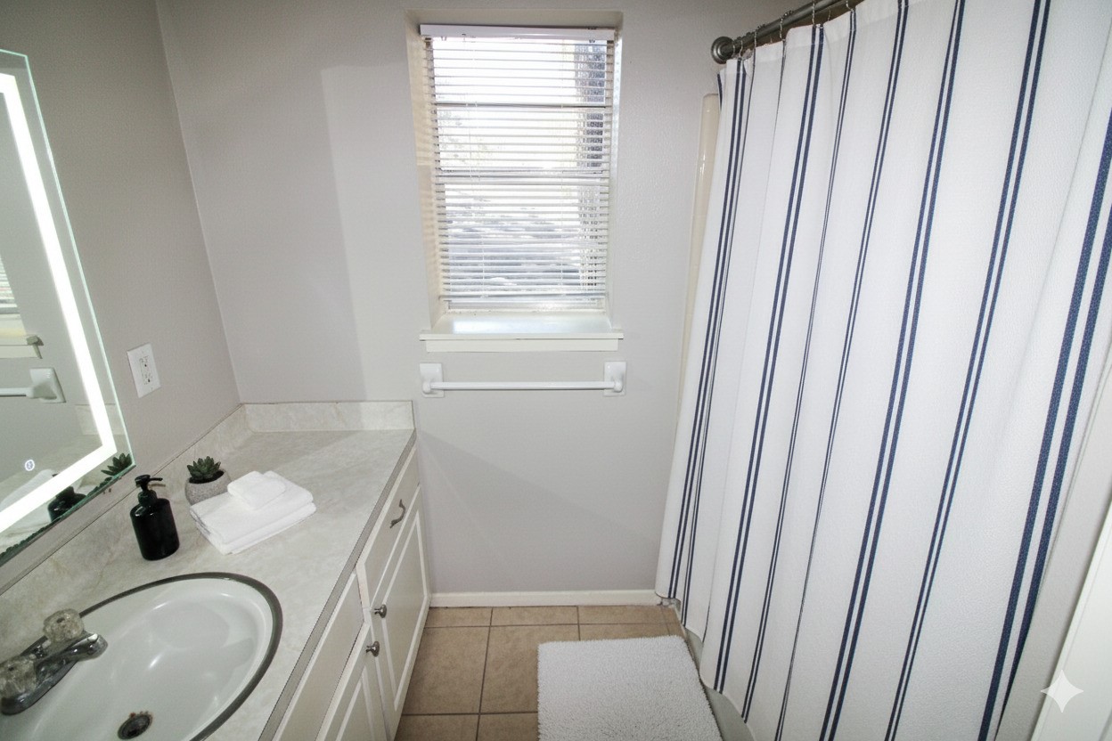 1305 Adams Street, Unit 1 Conroe, TX 77301 - Photo 4 of 14 a bathroom with a sink a toilet and tub