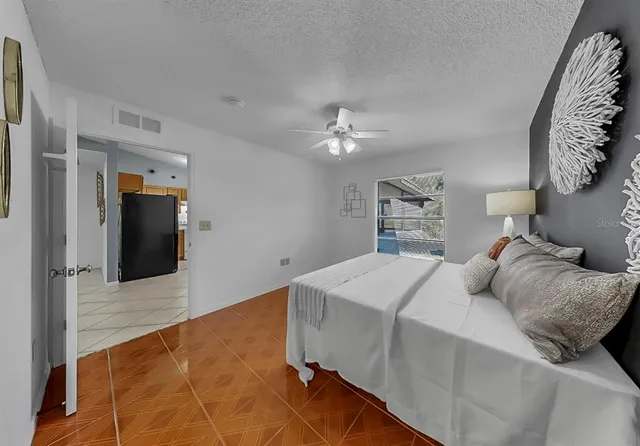 a bedroom with a large bed and a chandelier