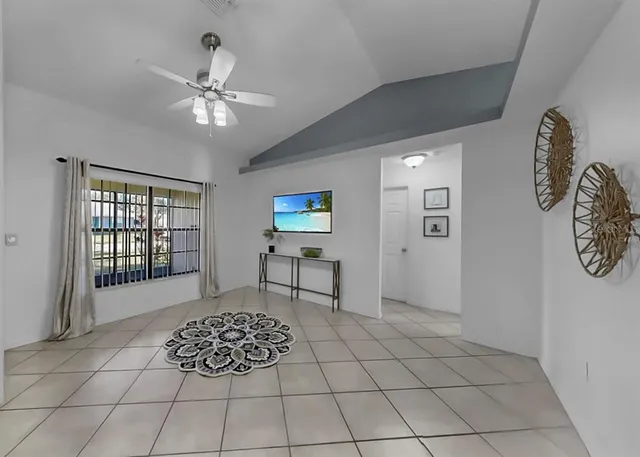 a living room with a baby crib and a window