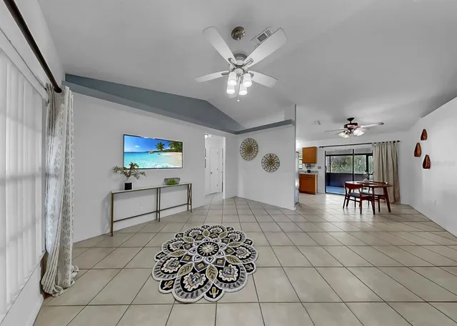 a living room with furniture and view of kitchen