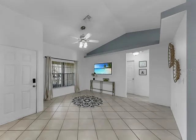 a kitchen with stainless steel appliances kitchen island granite countertop a sink a stove a dining table and chairs with wooden floor