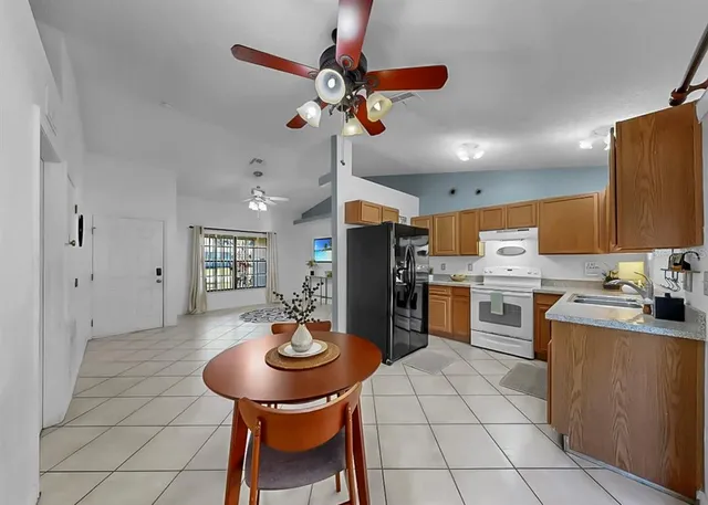 a kitchen with a table and chairs in it