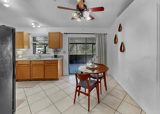 a kitchen with stainless steel appliances a dining table chairs and granite counter tops