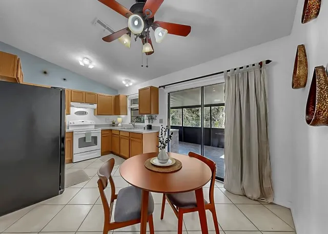 a view of a dining room with furniture and a window