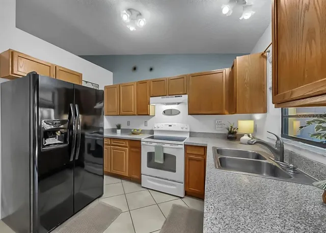 a kitchen with a sink stove and cabinets