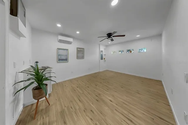 a view of a room with a potted plant and wooden floor