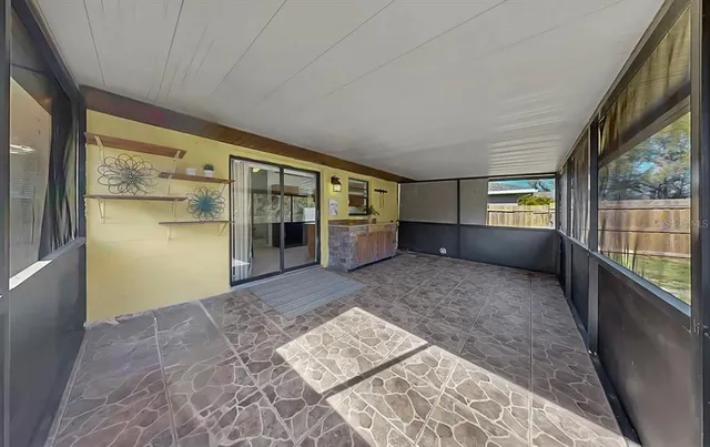 a view of a house with backyard and a tree