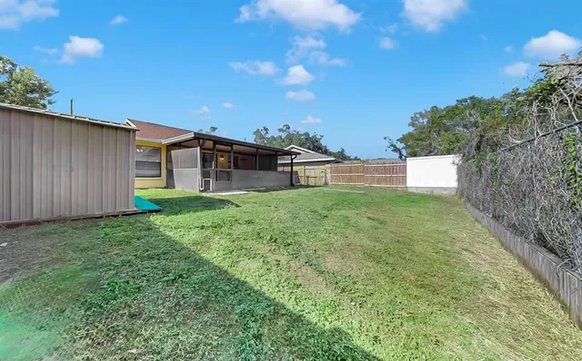 an aerial view of a house with garden space and street view