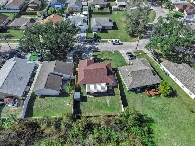 an aerial view of multiple houses with yard