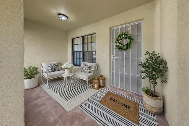 a living room with furniture and a potted plant