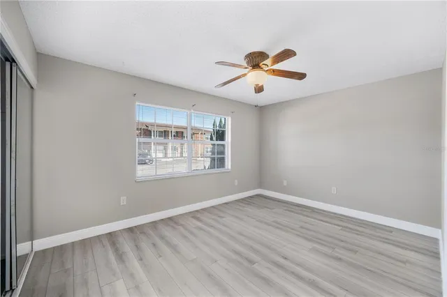 wooden floor in an empty room with a window