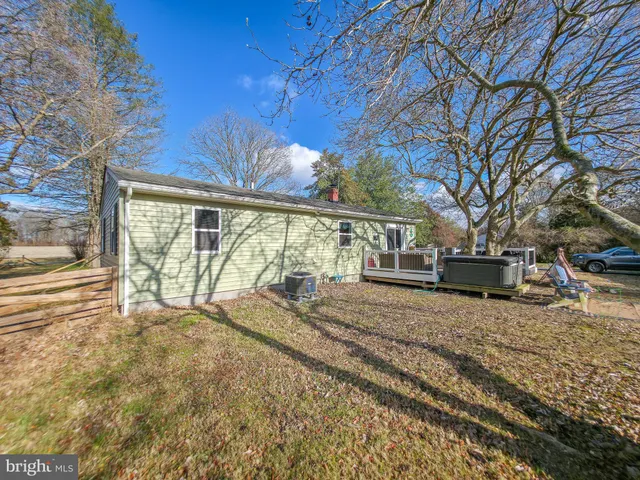 a view of a house with wooden fence