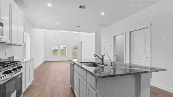 a kitchen with stainless steel appliances granite countertop a sink and stove